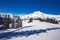 View to Alpine mountains surrounded by fog and ski slopes in Austria from Kitzbuehel ski resort.