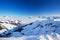 View to Alpine mountains surrounded by fog and ski slopes in Austria from Kitzbuehel ski resort