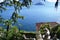 View to ancient sculptures of the Villa Monastero garden in Varenna, to the lake Como and Bellagio peninsula.