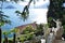 View to ancient sculptures of the Villa Monastero garden in Varenna, to the lake Como and Bellagio peninsula.