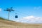 A view to a blue modern cableway cabin moving to the top of the