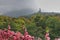 View to blurred due fog silhouette giant statue bronze Buddha on hill surrounded rainforest