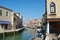 View to the channel, boats, buildings and people at the street in early spring in Murano, Italy.