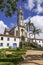 View to church through stoney gate, blue sky with white clouds, Sanctuary Caraca, Minas Gerais, Brazil