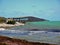 View to disused bridge in the Florida Keys, in the foreground beach partly polluted with stranded material