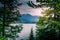 View to dramatic Lake at Yellowstone National Park through pine trees