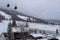 View to the foggy, snowy Landscape, the Gondula and Skiing Slopes of Churwalden, Switzerland in Wintertime