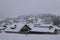 View to the foggy, snowy Landscape and the Houses of Churwalden, Switzerland in Wintertime