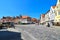 View to the German medieval town of Lueneburg. You see the marketplace with facades of bricks and small shops with tourists