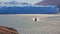 View to glacier landscape with tourist boat sailing on dazzle blurred surface of lake  near famous Perito Moreno glglacier.