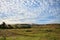 View to hills of savanna under stunning sunny cloudy sky