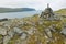 View to the Mageroya Cape and sea with the stack of stones at the fore ground in North Cape, norway.