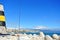 A view to Mediterranean sea, a lighthouse with breakwaters, fishing rods of locals and Torremolinos at the background