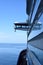 View to the navigation bridge of a cruise ship on the port side with calm sea and blue sky in the back