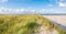 View to North Sea from dunes with marram grass and beach of nature reserve Boschplaat on Terschelling, Netherlands