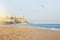 A view to a resort hotel building at the seashore, a seagull and