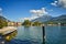 view to Riva del Garda, mountains, Monte Brione, lake, water, pier, promenade, pale, blue sky
