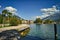 view to Riva del Garda, mountains, Monte Brione, lake, water, pier, promenade, pale, blue sky