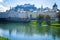 View to river quay and colorful buildings with fortress background in Salzburg Austria at autumn