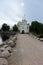 View to the road and entrance gate of Nilov Monastery on Stolobny Island, lake Seliger, Ostashkov, Russia