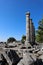 View to the ruins of ancient temple of Athena in archaeological site Priene, Turkey with marble column fragments on the foreground