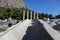 View to the ruins of ancient temple of Athena in archaeological site Priene, Turkey with marble column fragments on the foreground