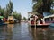 View to several mexican boats with tourists and gondoliers at cute Xochimilco`s Floating Gardens in Mexico