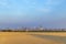 View to skyline of Frankfurt am Main with golden harvested field