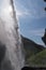 View to the sun through the Kvernufoss waterfall, Iceland