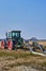 View to a tractor and a machine that are ready to prepare an asparagus field in Germany for cultivation