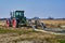 View to a tractor and a machine that are ready to prepare an asparagus field in Germany for cultivation