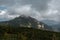 View of Toaca peak against the background of the cloudy sky. Romania, Ceahlau mountains.