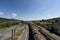 View from the top of the bridge standing above the railway in Transylvanian region in Romania. Wood transportation train during a