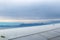 View of the top of Mt. Olympus in Greece poking out of a thick fog from an airplane with wing in foreground