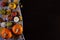 The view from the top of the pumpkin, chestnut, autumn leaves and apple on dark brown wooden background