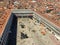 A view from the top of St Marks Campanile of St Marks Square looking down on the square with tourists below and the amazing city