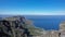 View from the top of Table Mountain in Cape Town. Curvy Atlantic coastline, town houses.