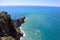 View from the top of the wall of Alanya fortress to surrounding cliffs and rocks and azure mediterranean sea