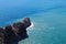 View from the top of the wall of Alanya fortress to surrounding cliffs and rocks and azure mediterranean sea