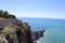 View from the top of the wall of Alanya fortress to surrounding cliffs and rocks and azure mediterranean sea