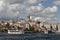 View of tour boats on Golden Horn area of Bosphorus in Istanbul. Galata tower and Beyoglu district are in the background.