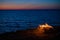 View from a tourist tent on bonfire on the seashore at sunset