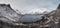 View from the tourist viewpoint Bergsbotn on the Senja peninsula in northern Norway. Snow-capped mountain peaks surround a valley