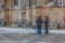 View of tourists talking on exterior close to the Gothic exterior facade of the Monastery of Batalha, Mosteiro da Batalha,