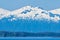 A view towards the forested shoreline of the Gastineau Channel approaching Juneau, Alaska