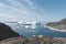 View towards Icefjord in Ilulissat. Icebergs from Kangia glacier in Greenland swimming with blue sky and clouds. Symbol