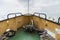 View towards the prow of a motor ship sailing the estuary of the Thames in Englang, UK, with the sea and the horizon in the