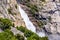 View towards Wapama falls dropping along granite walls; Hetch Hetchy Reservoir area, Yosemite National Park, Sierra Nevada