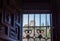 View of a tower of the Alhambra behind the bars of a window