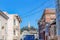 View of a tower on top of a hill from a neighborhood with victorian houses at San Francisco, CA